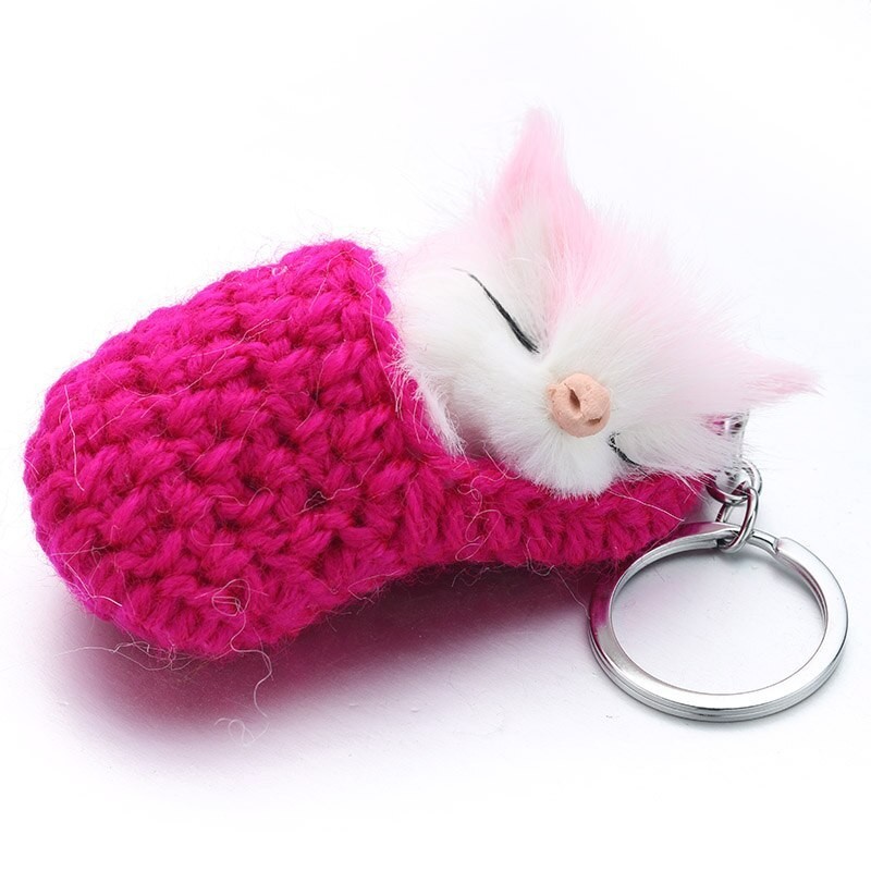 Sleeping cat in a hand-woven cot - keychainKeyrings