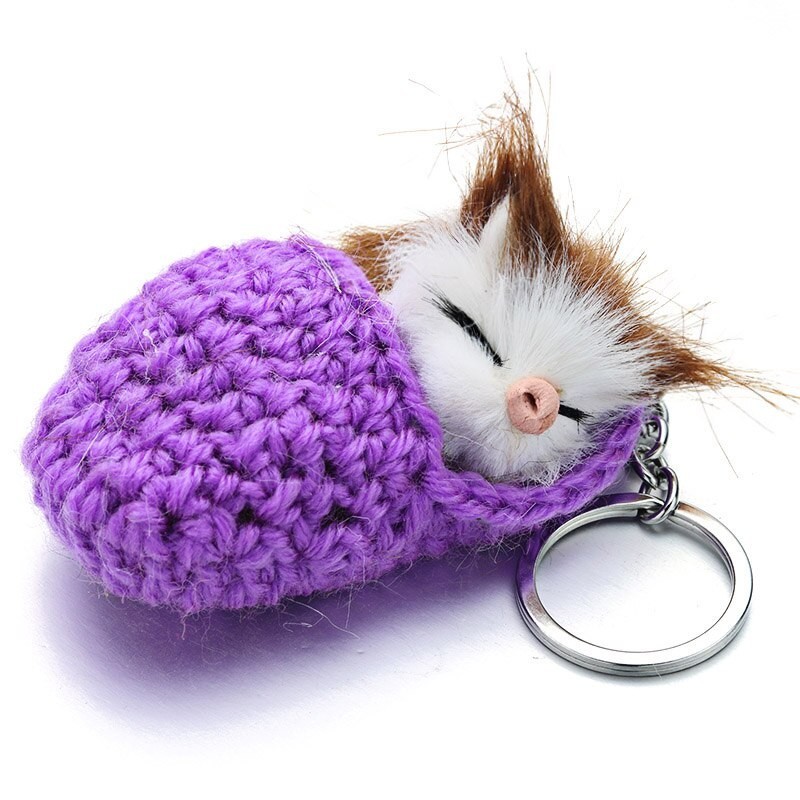 Sleeping cat in a hand-woven cot - keychainKeyrings