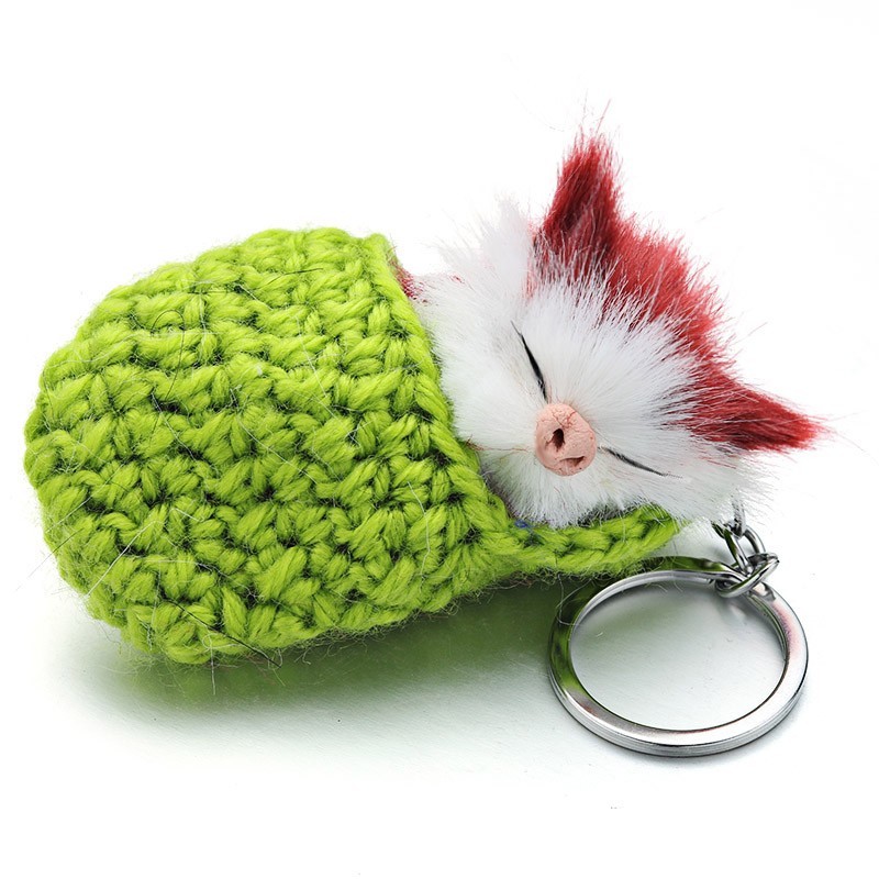 Sleeping cat in a hand-woven cot - keychainKeyrings
