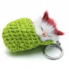 Sleeping cat in a hand-woven cot - keychainKeyrings