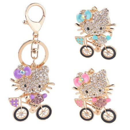 Gatinho de cristal em uma bicicleta - chaveiro