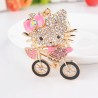 Gatinho de cristal em uma bicicleta - chaveiro