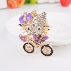 Gatinho de cristal em uma bicicleta - chaveiro