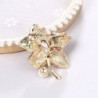 Flor com cristal/pérola - broche dourado