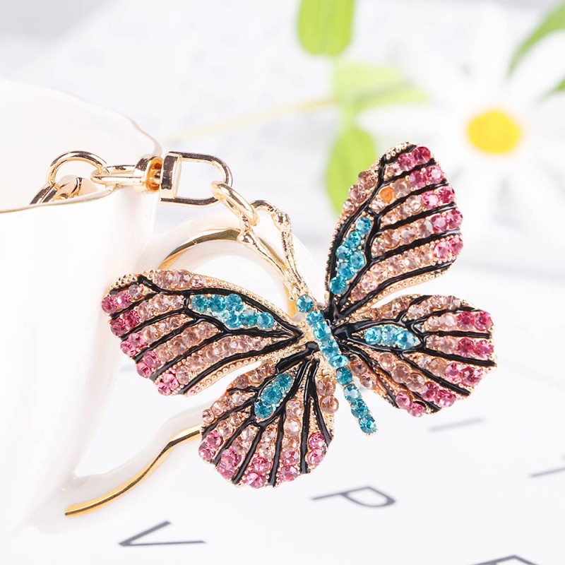 Chaveiro dourado com borboleta de cristal