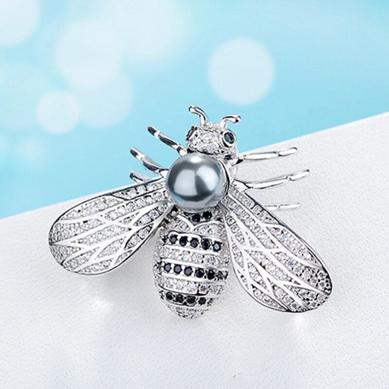 Bee shaped silver brooch - with a pearlBrooches